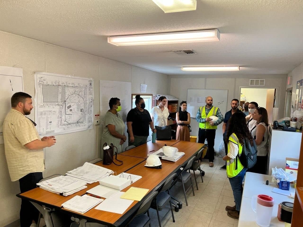 Site meeting with the HTE field crew around project drawings